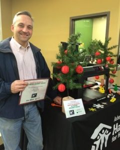 Roger Gauthier stands next to a display of his winning 3D ornament.