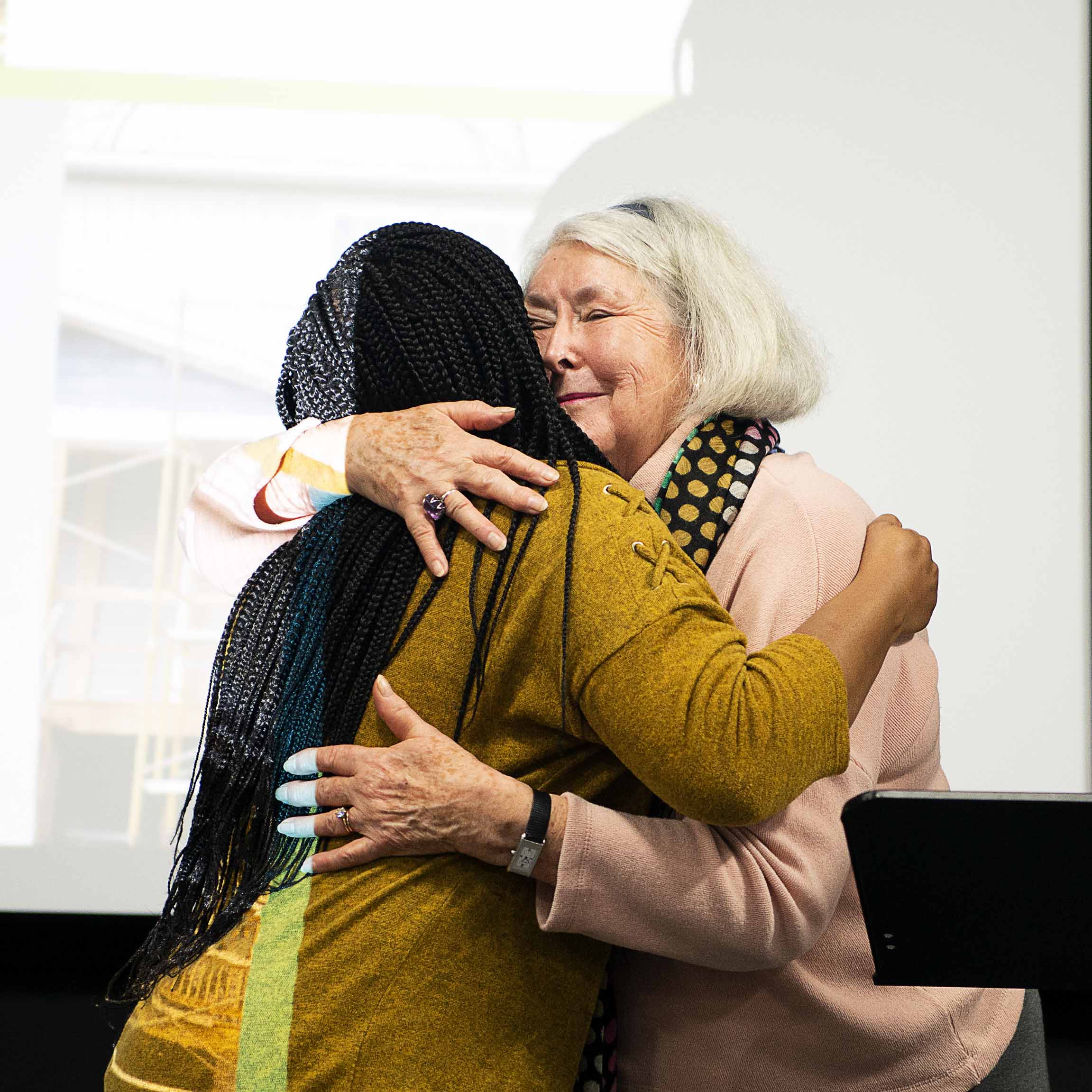 Two women share an embrace