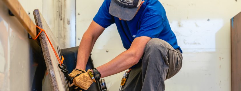 A ReStore truck driver straps down a sink from a Deconstruction job.