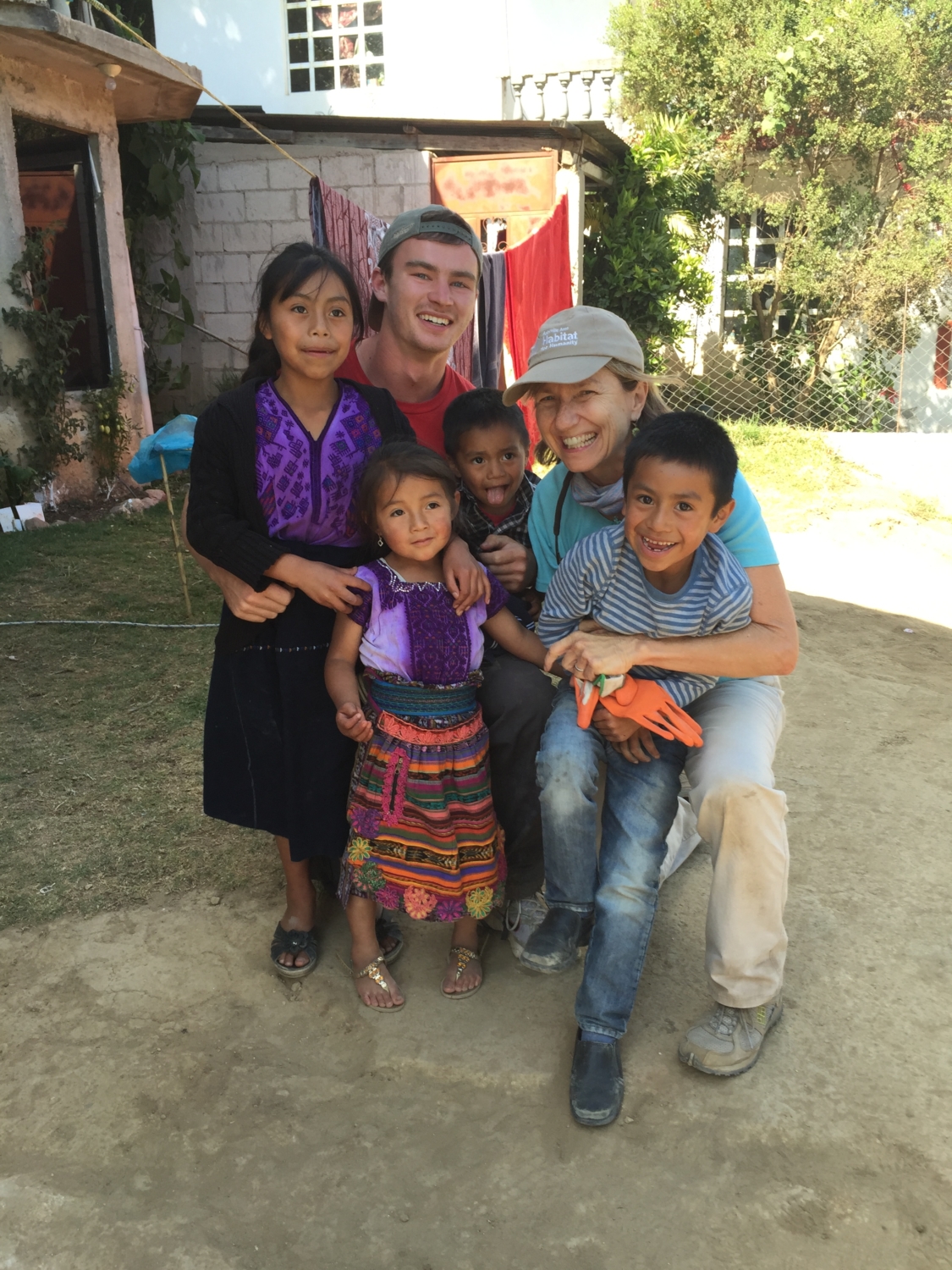 Volunteers hug local children in Guatemala.